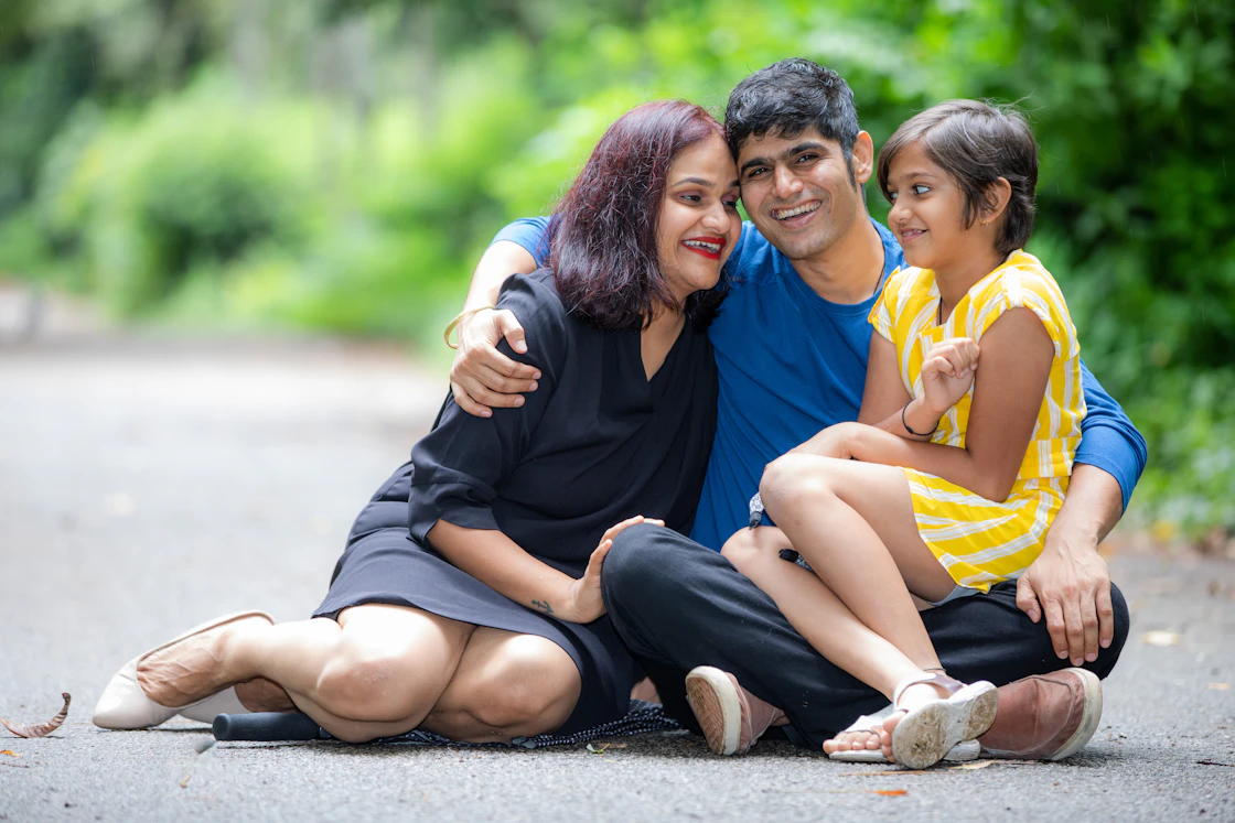 Happy Indian family sitting together outdoors