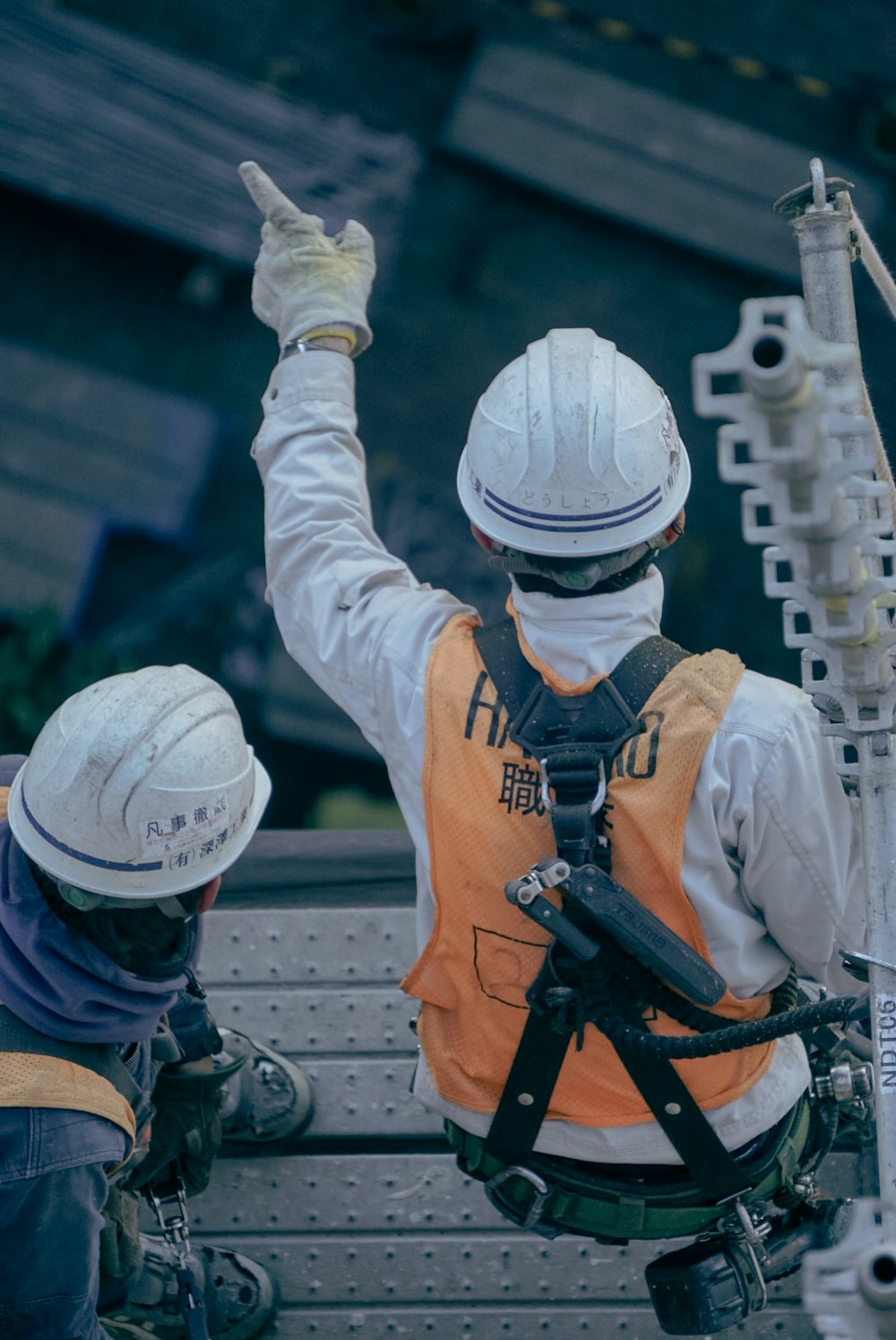 two men in safety gear sitting on a bench