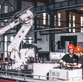 two workers in a factory working on a project