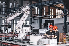 two workers in a factory working on a project
