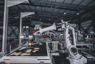 a factory with a robot working on a piece of machinery