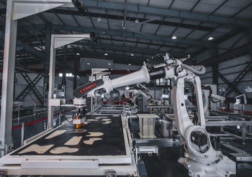 a factory with a robot working on a piece of machinery