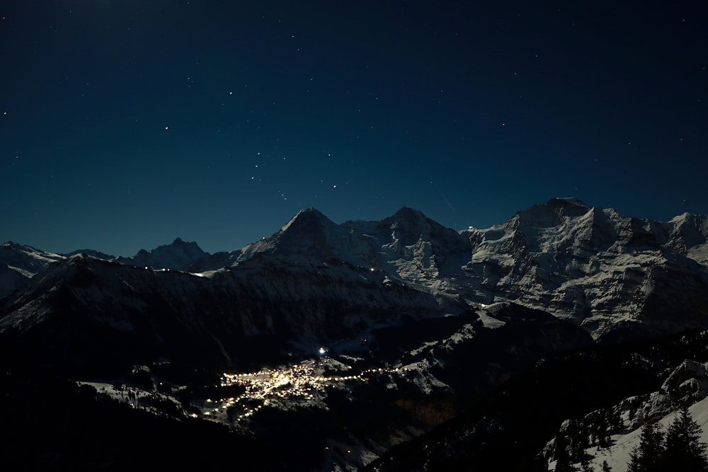a night view of a snowy mountain range