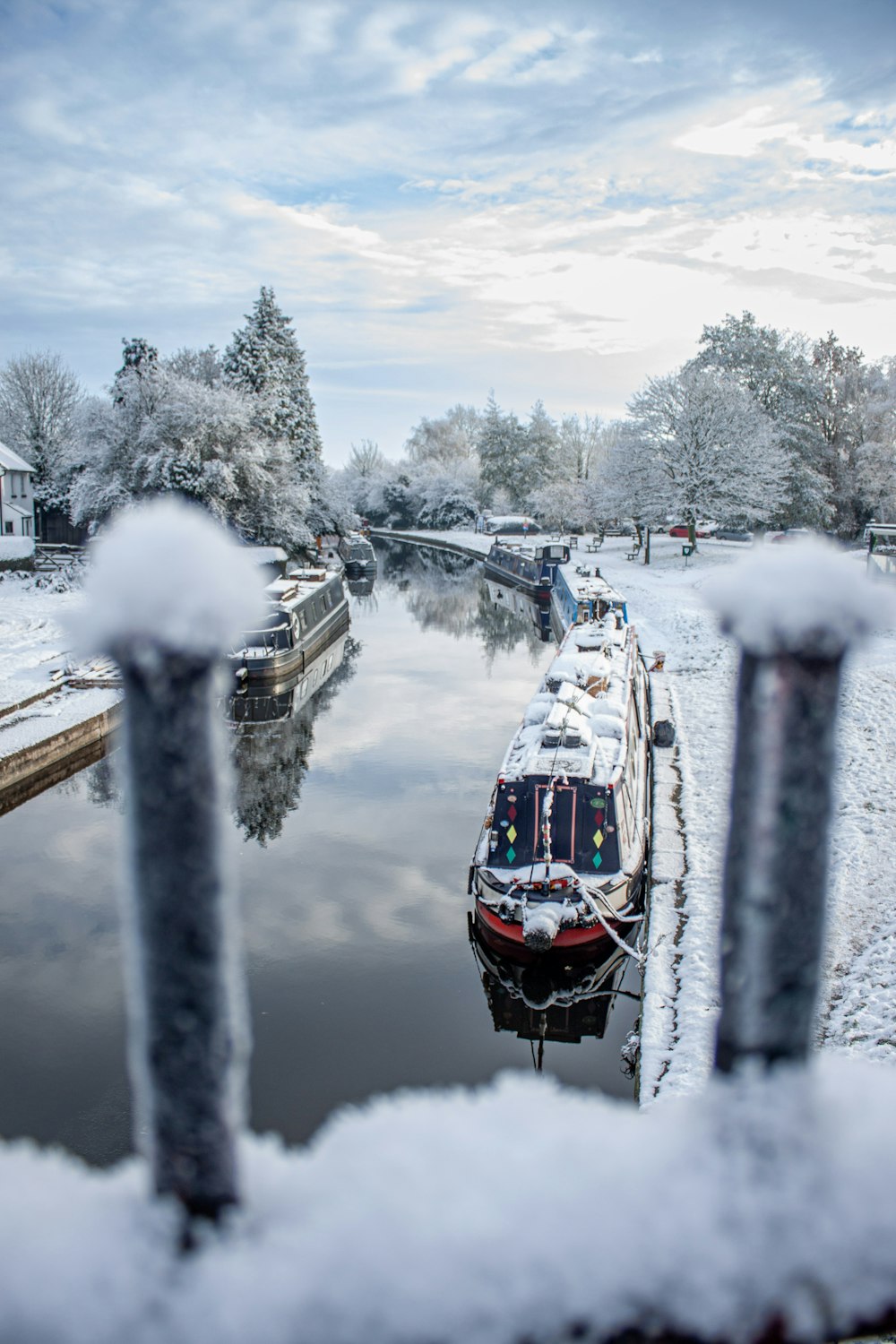 a boat is docked in a snowy canal