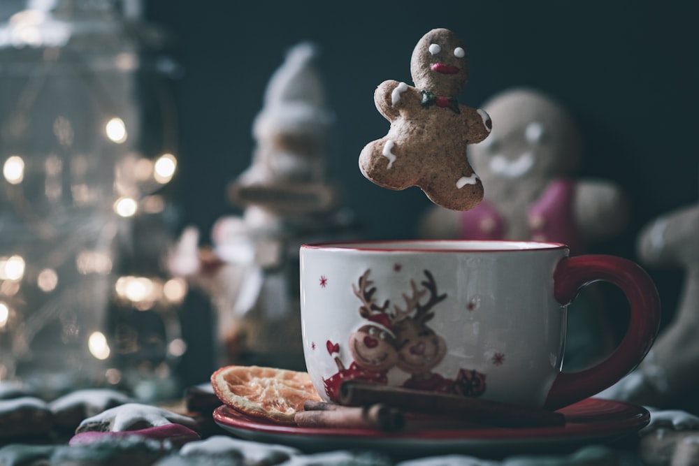 a cup of coffee with a cookie on top of it