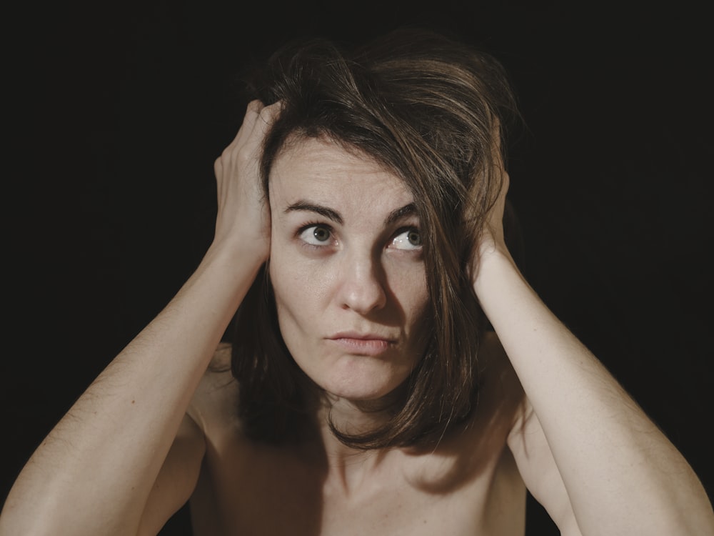 a woman holding her head in her hands