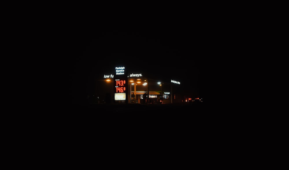 a gas station is lit up at night