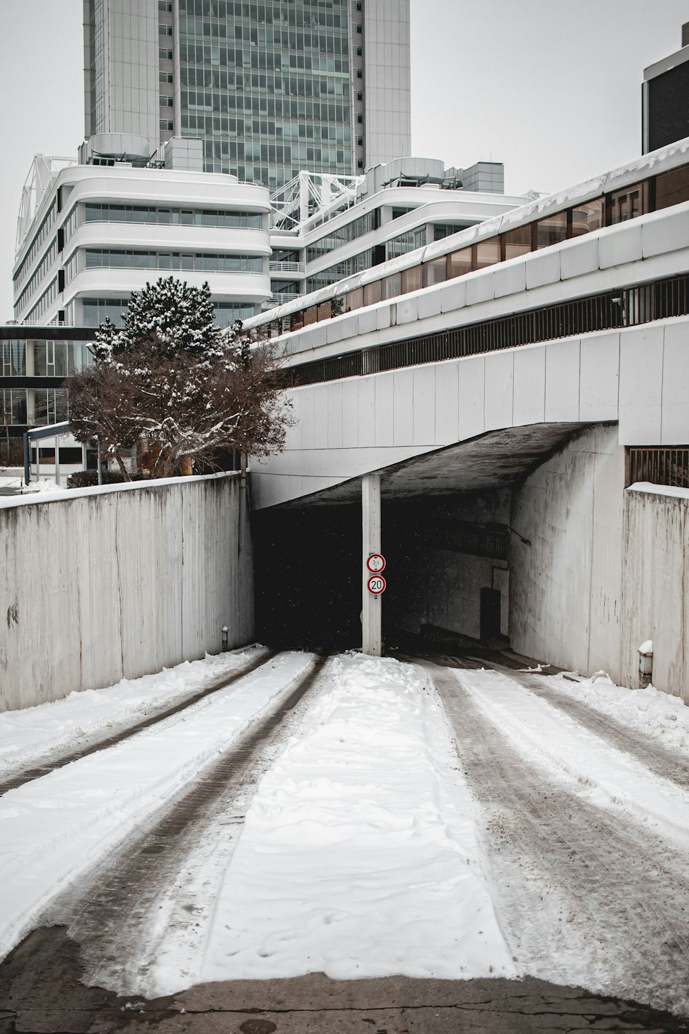 a snow covered road with a stop sign in the middle of it