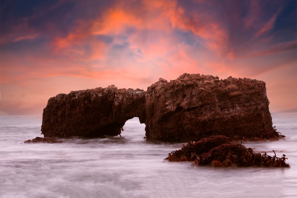 a rocky outcropping in the middle of the ocean