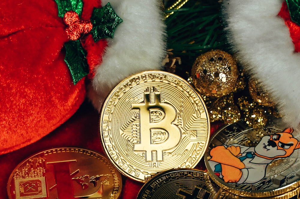 a bunch of bitcoins sitting next to a christmas tree