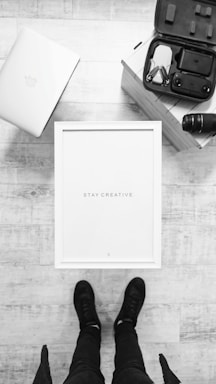 A serene workspace with a camera, drone, and laptop ready for creative projects.