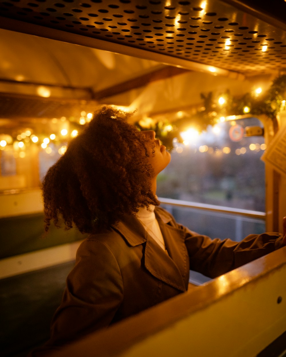 a woman looking out the window of a bus