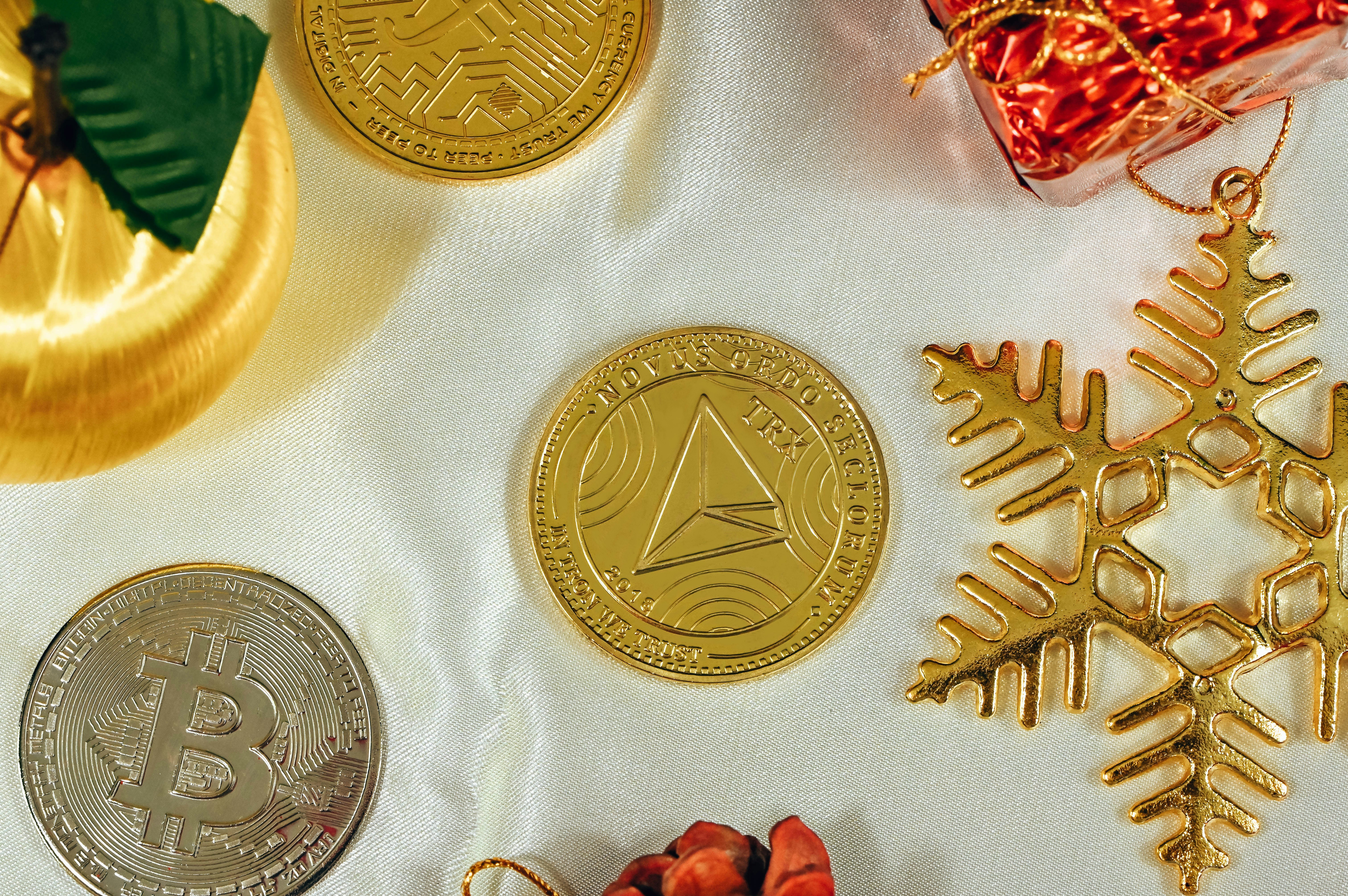 Tron coin, Bitcoin, and Filecoin with Christmas ornaments