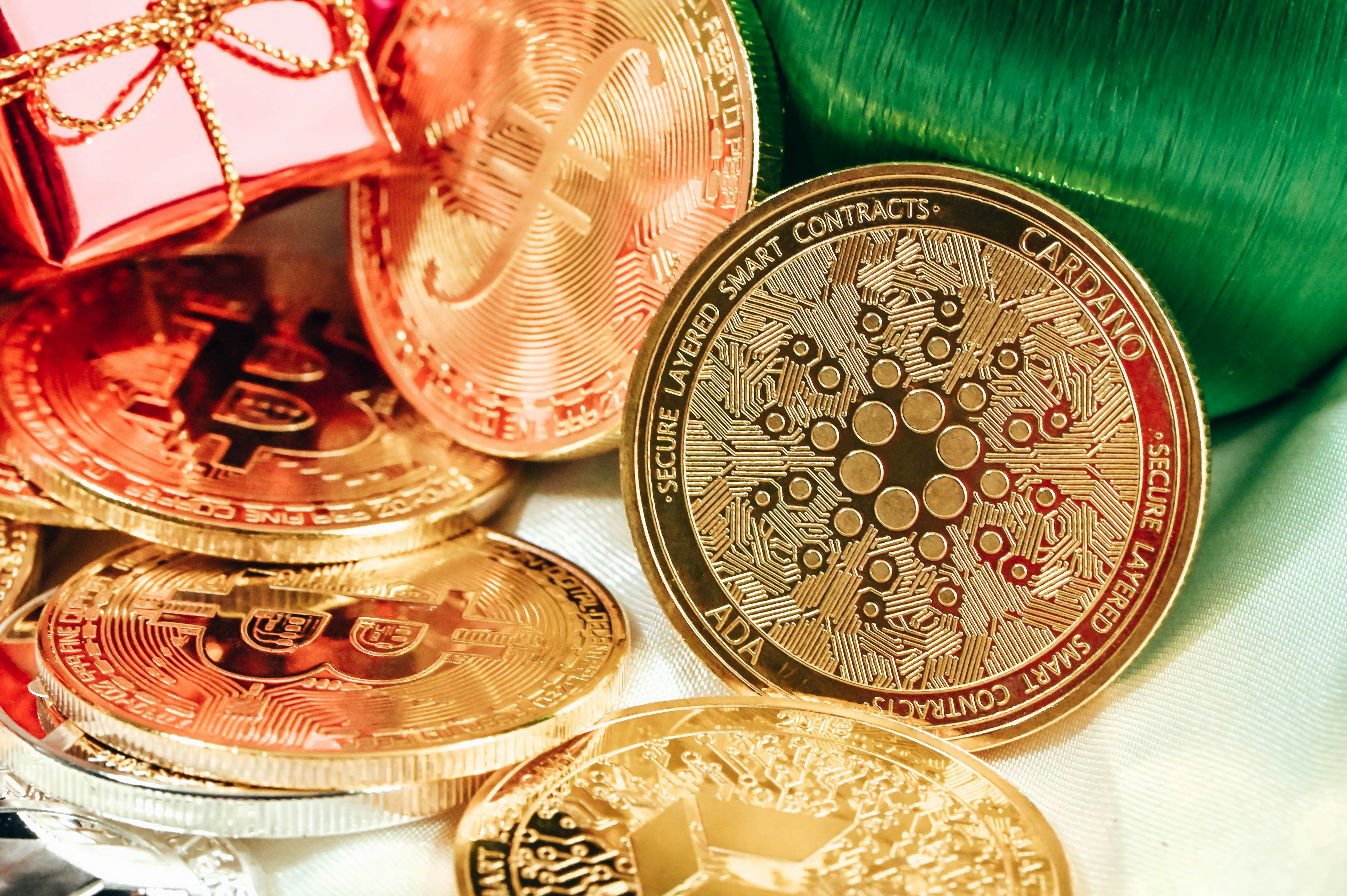 A group of cryptocurrency coins with Christmas ornaments