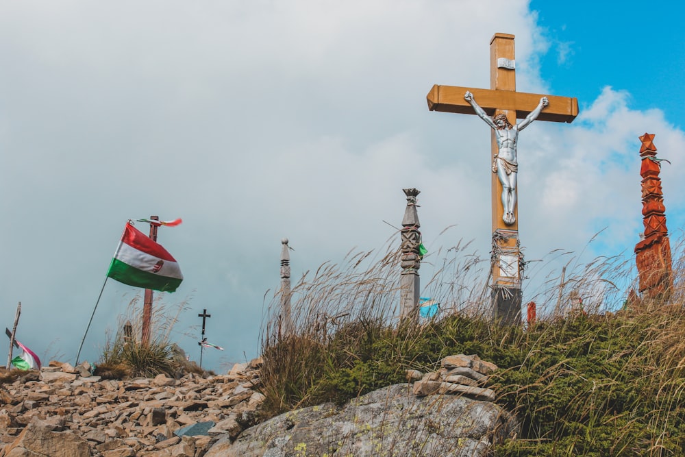 a cross on top of a hill with a flag on it