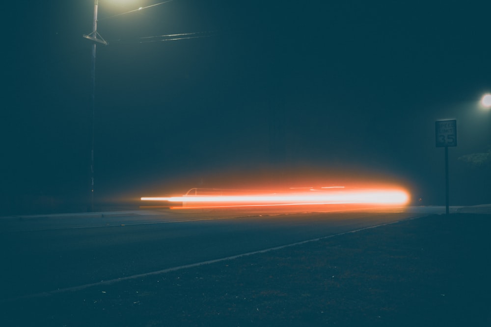 a car driving down a street at night