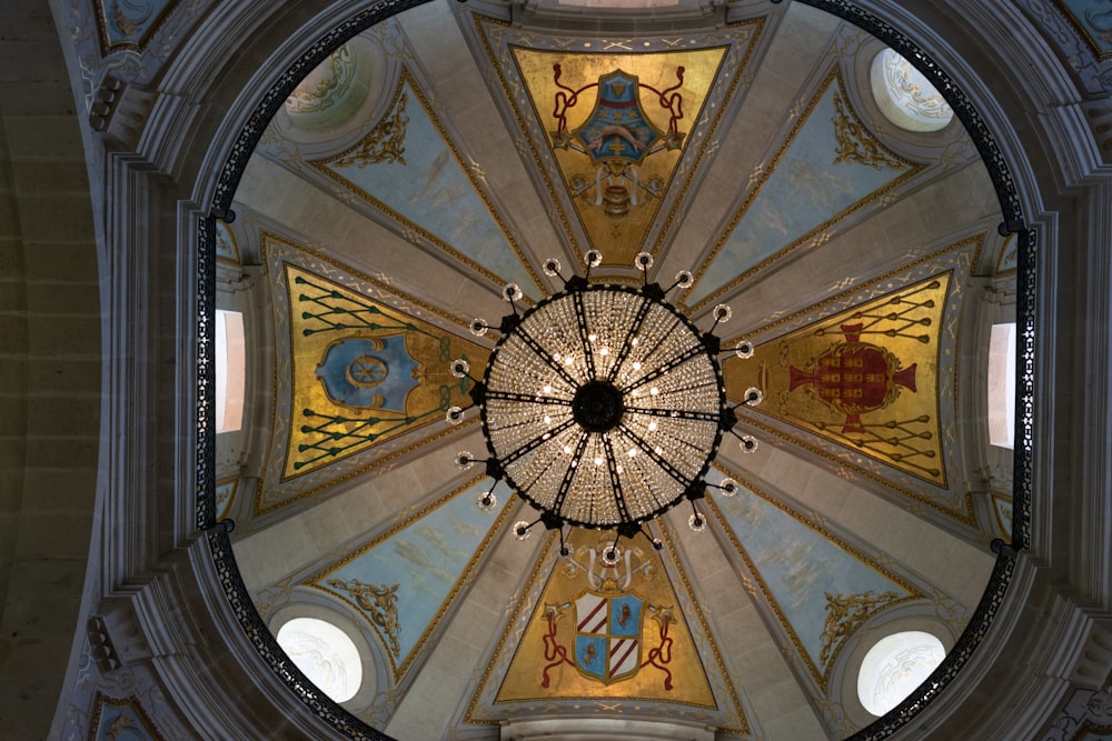 the ceiling of a church with a circular chandelier