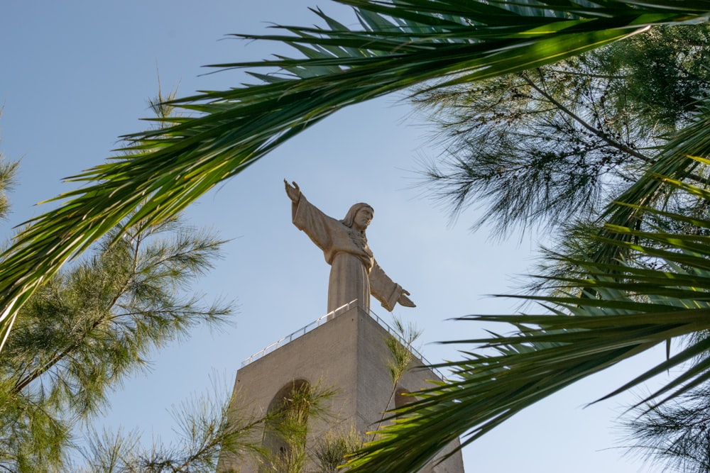 a statue of jesus on top of a building