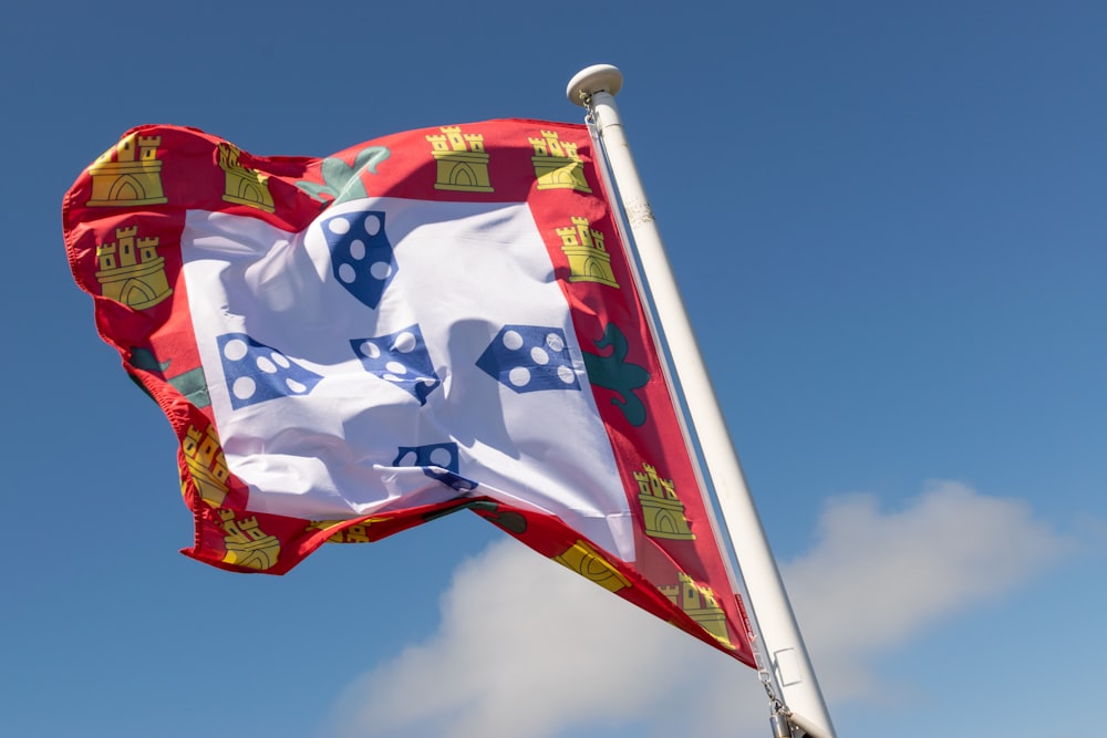 a red and white flag flying in the wind