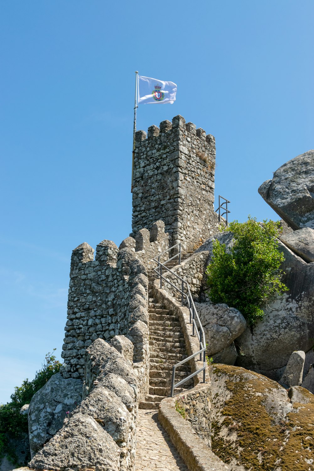 a stone castle with a flag on top of it