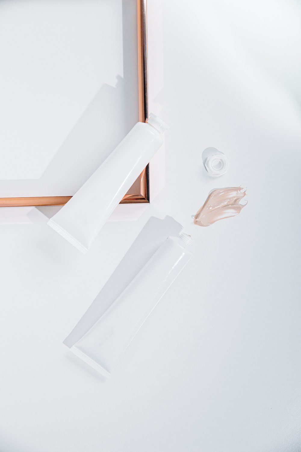 a close up of a white table with a gold frame