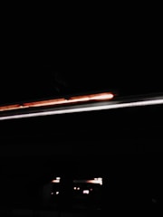 A moody, avant-garde music video scene with bold lighting and artistic shadows.