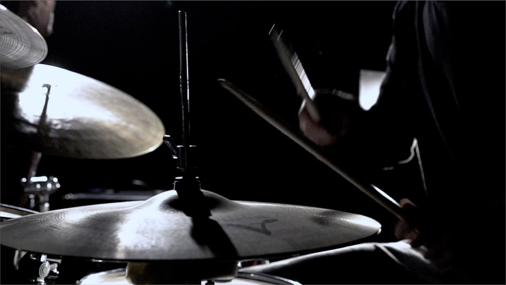 a man playing drums in a dark room