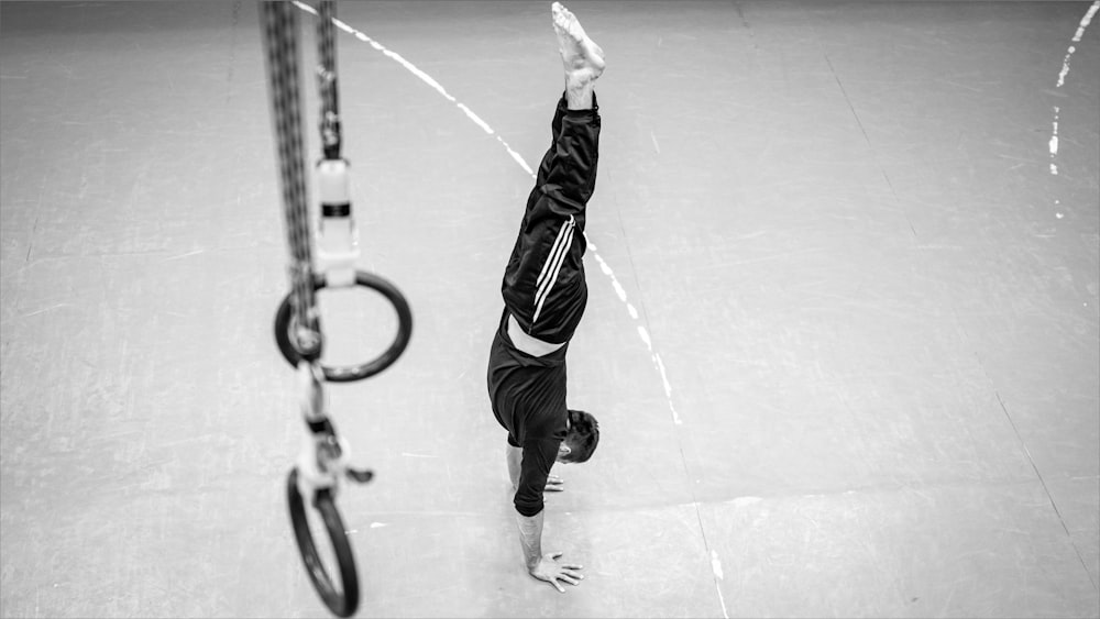 a person doing a handstand on a court