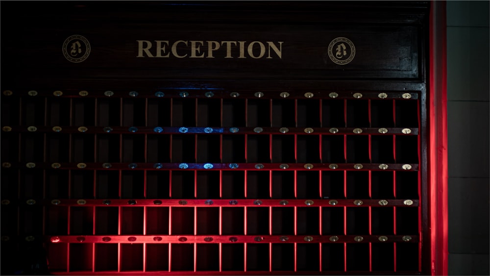 a close up of a metal door with a red light