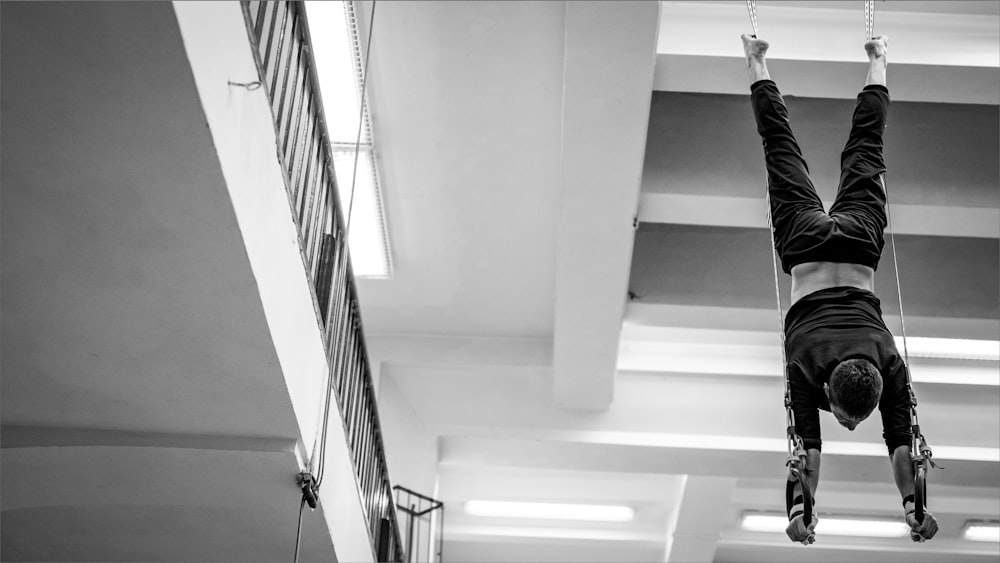 a person is doing a handstand in a building