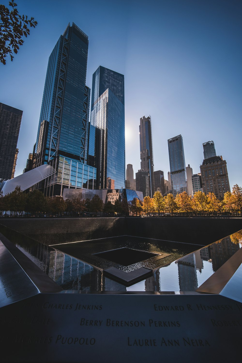 a view of a city skyline from a reflecting pool