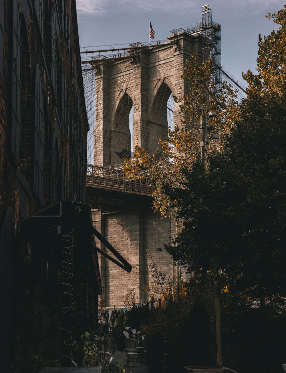 a view of the brooklyn bridge from the side of a building
