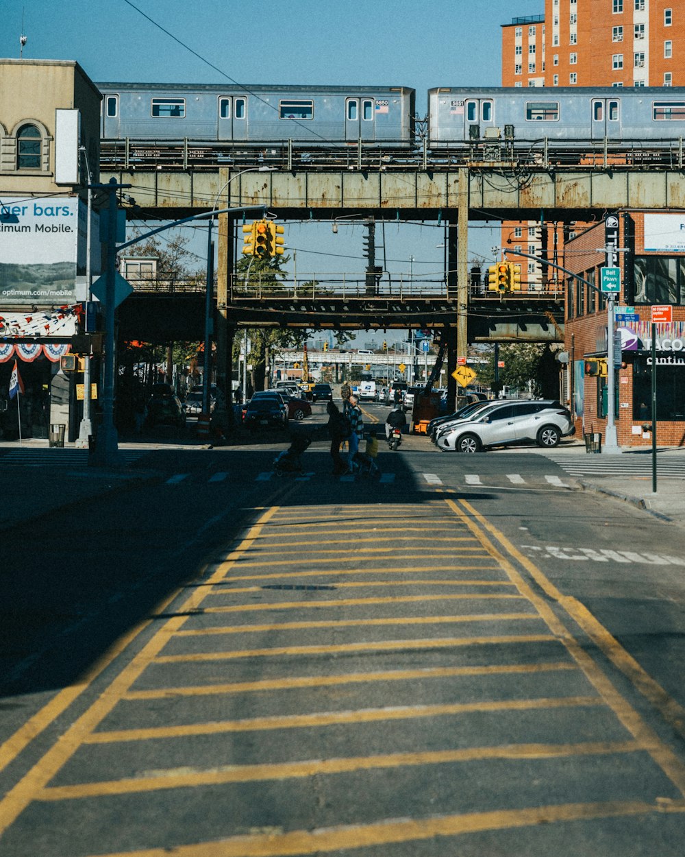 a train traveling over a bridge over a street