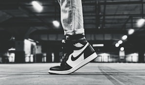 Lifestyle shot of a model wearing aviator shoes in an urban setting.