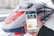 A person is holding a smartphone displaying the LiveJournal app, with a sleek, modern high-speed train positioned in the background at the station. The phone screen shows various posts including text and images.