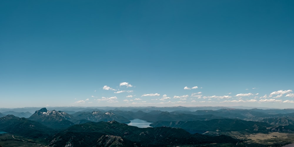 a view of a mountain range with a lake in the distance