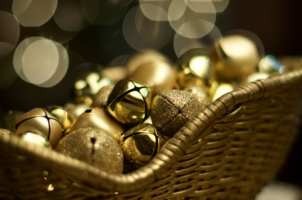 a basket filled with gold and silver ornaments