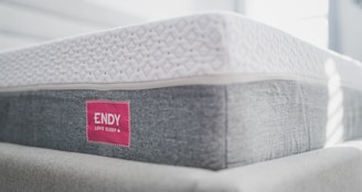 a close up of a mattress with a red label on it