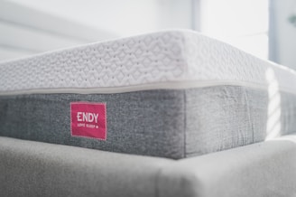 a close up of a mattress with a red label on it