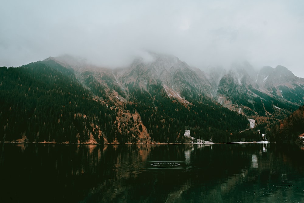 a mountain range with a lake in the foreground