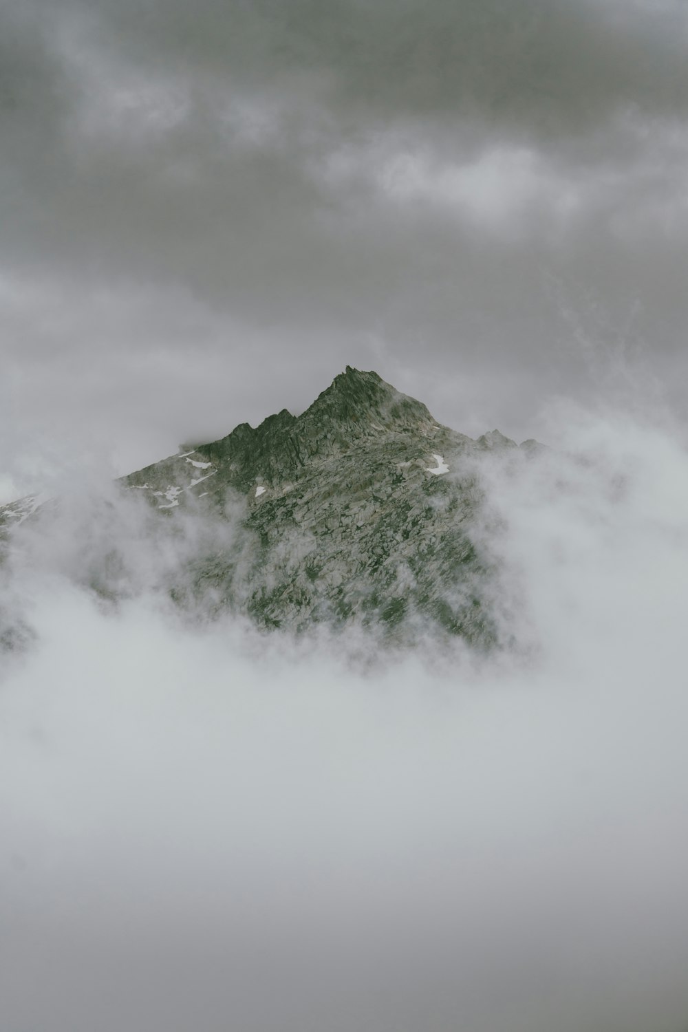 a view of a mountain in the clouds