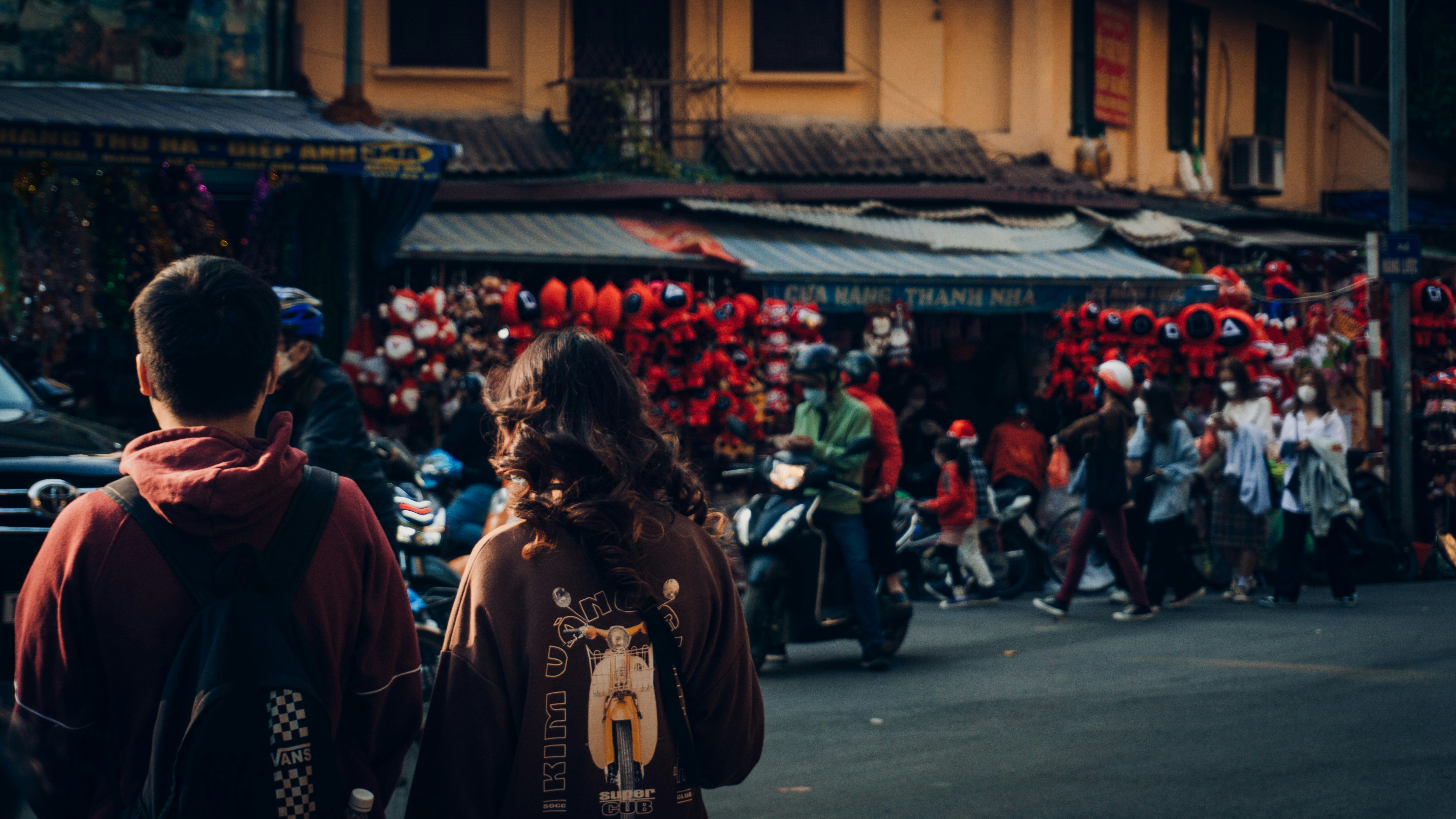 a man and a woman walking down a street