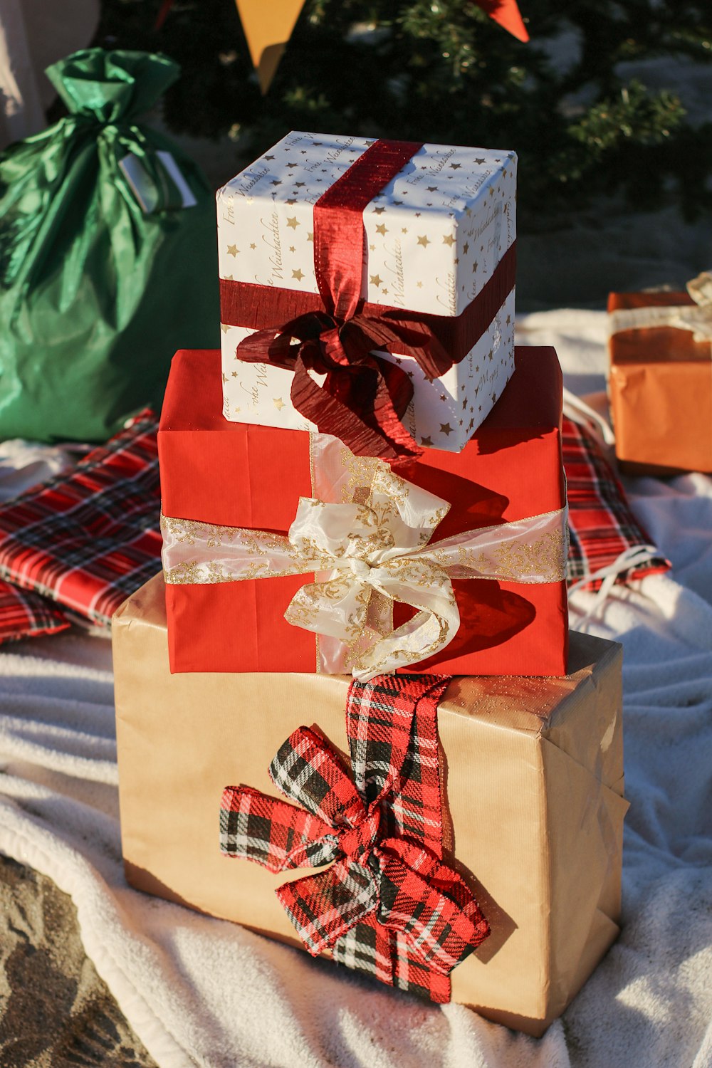 a stack of wrapped presents sitting on top of a blanket