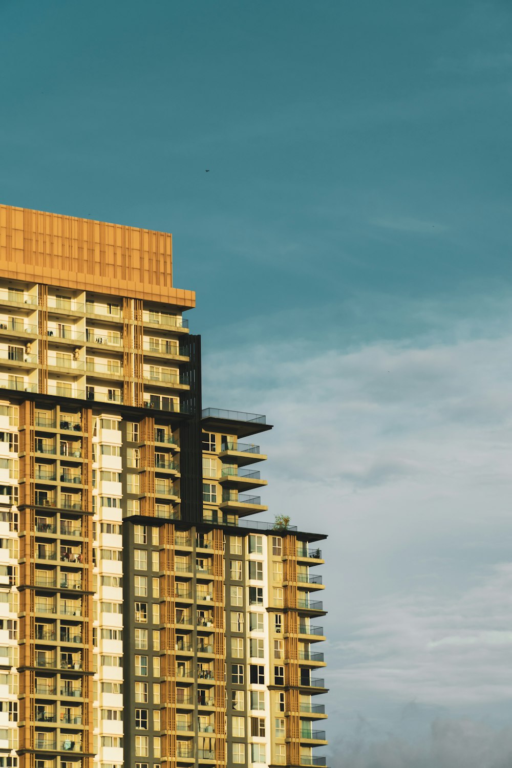 a tall building with balconies on top of it