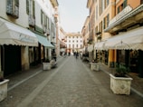 A picturesque Italian street lined with cafes and shops.