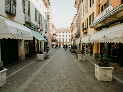 A picturesque Italian street lined with cafes and shops.