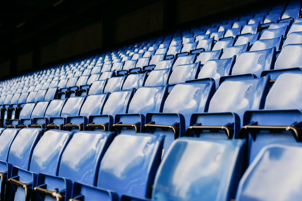 a row of blue seats in a stadium