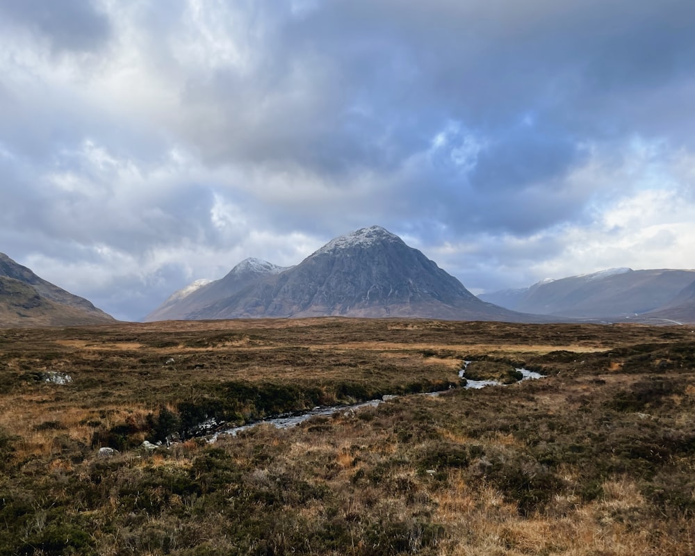 a mountain range with a stream running through it