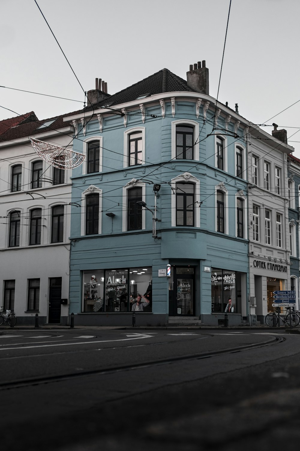 a blue building sitting on the corner of a street