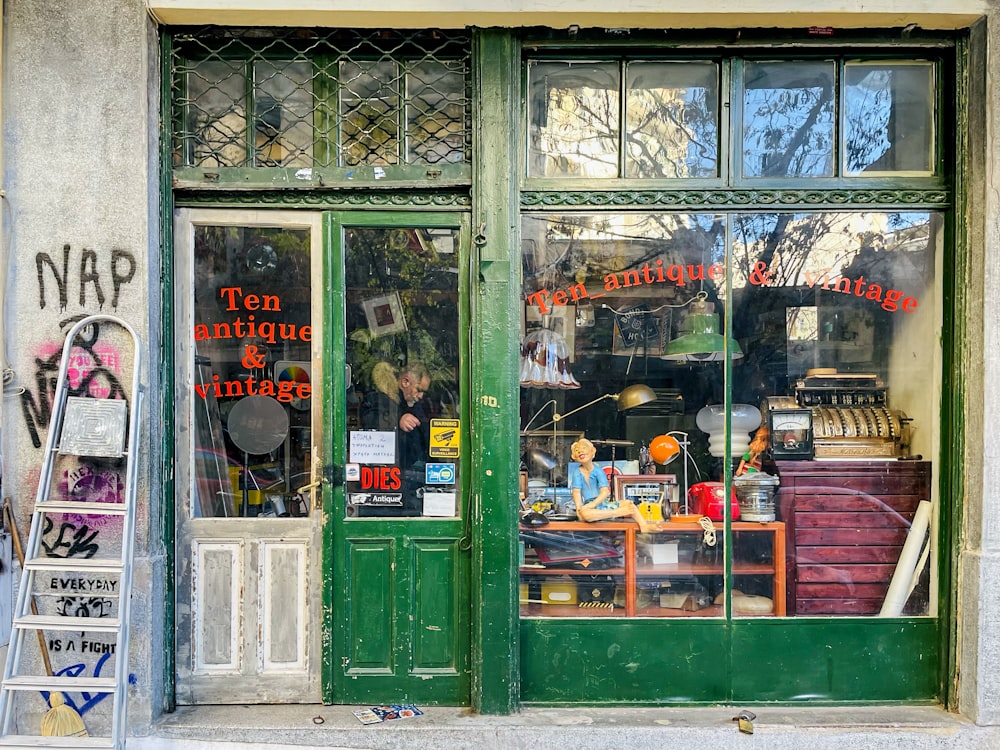 a store front with a green door and window